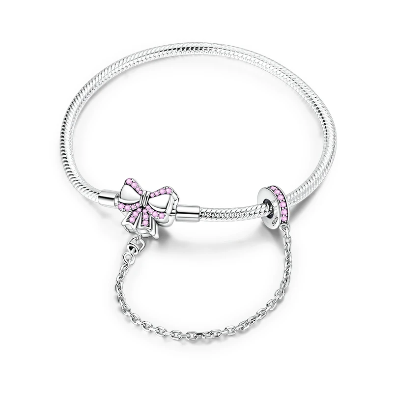 Pulseira em prata de lei 925 com fecho em laço de fita rosa cravejado de zircónias e corrente de segurança.