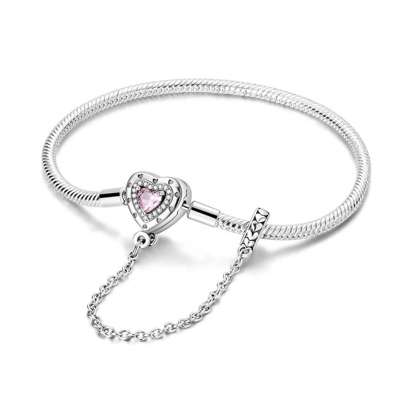 Pulseira de prata com fecho de coração cravejado de zircónia rosa e corrente de segurança.