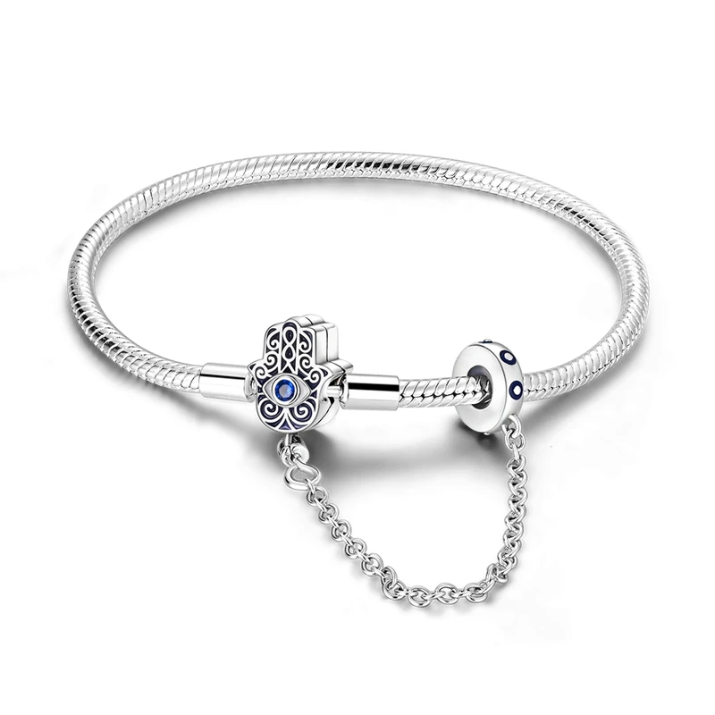 Pulseira em prata com fecho Mão de Fátima e corrente de segurança com Olho Grego, detalhes em zircónia.