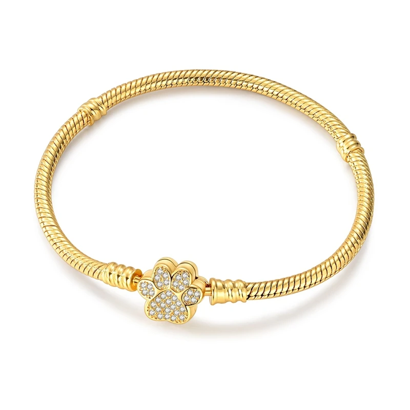 Pulseira dourada com fecho em forma de pata de animal cravado de zircónias.